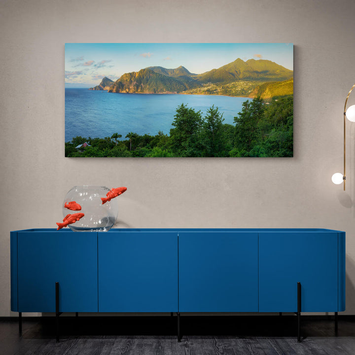 A canvas print of "Grand Bay at Sunrise" by Yuri A Jones on a light brown colored wall, hung above a blue cabinet.