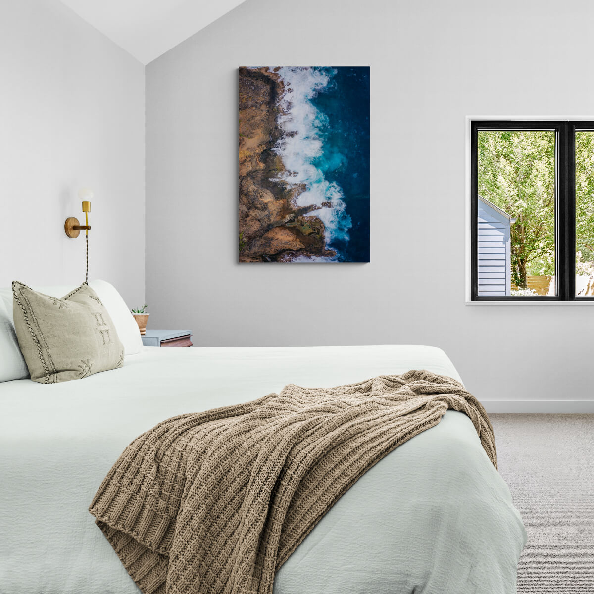 A canvas print of "L'escalier Tete Chien II" by Yuri A Jones on a white wall, next to a window.