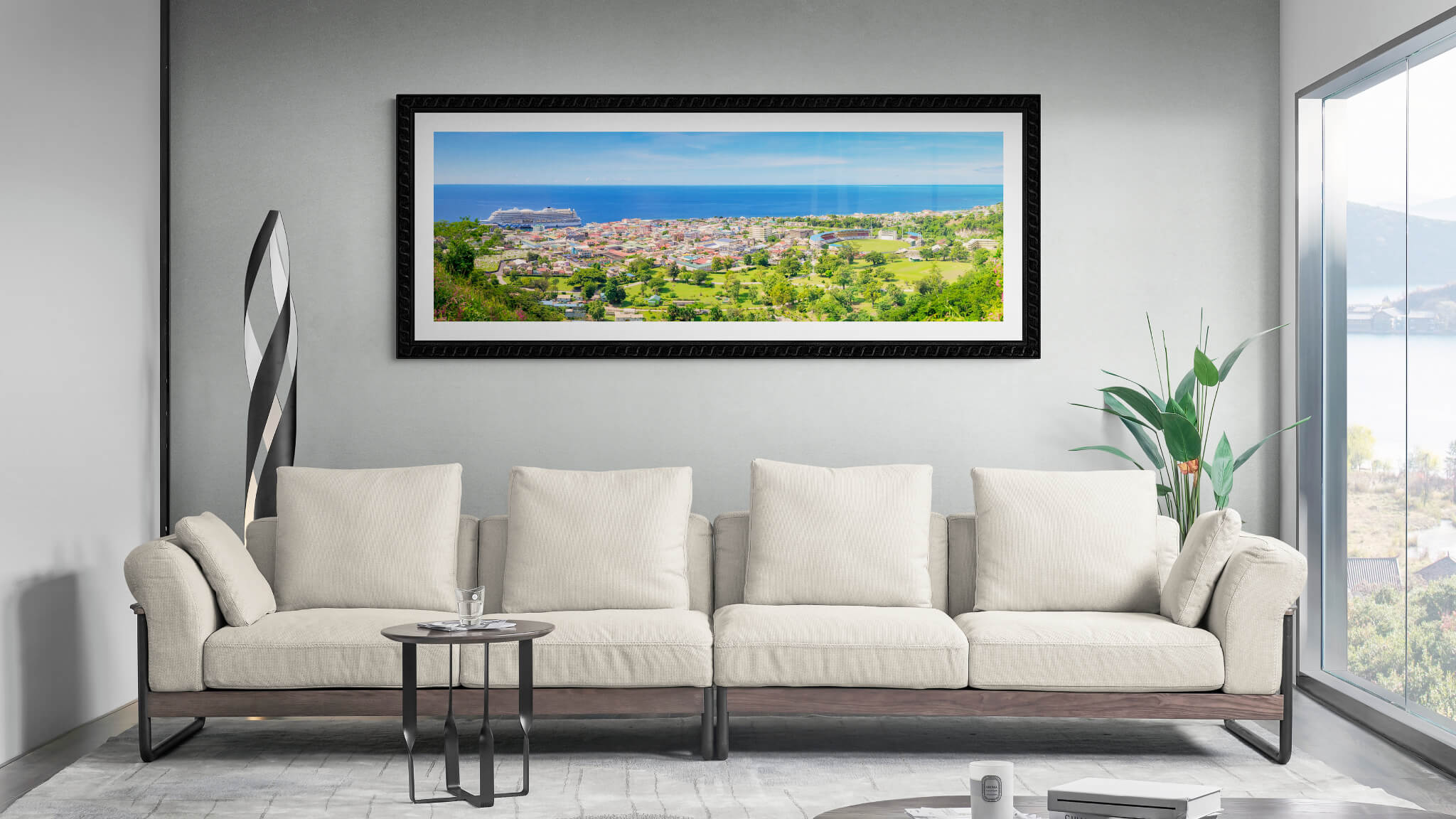 Panoramic framed print of Roseau (from Morne Bruce) hung in a room above a couch.