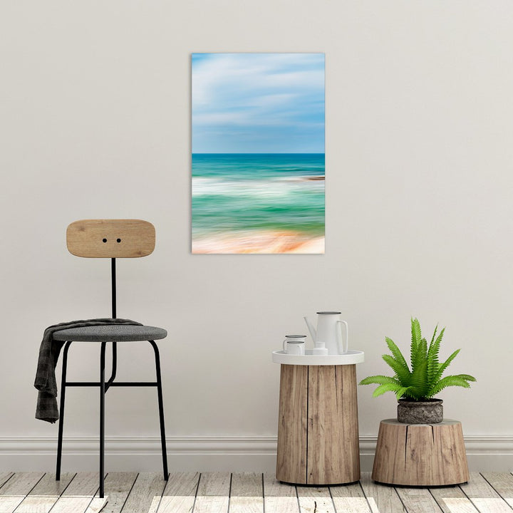 Canvas print of "Seascape Abstract III" by Yuri A Jones, hung on a wall, just above a tree stump and chair.