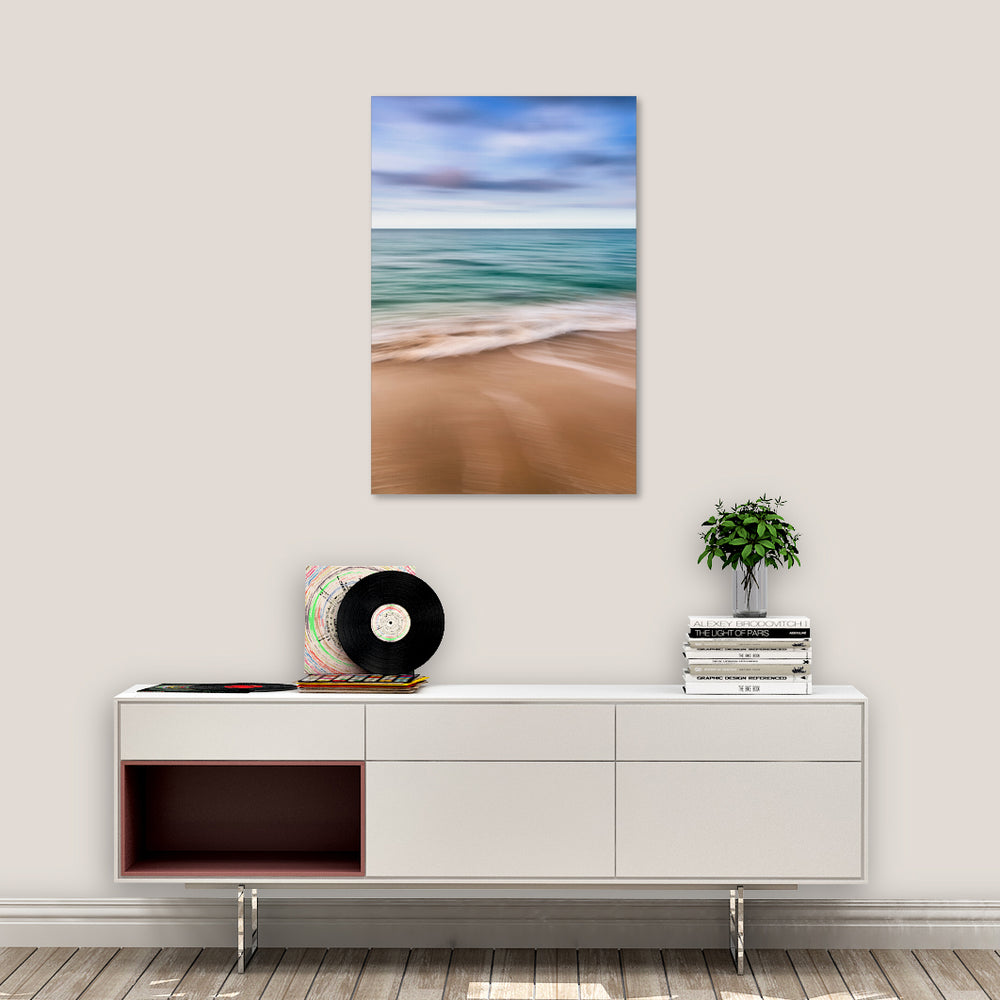 Canvas print of "Abstract Seascape II" by Yuri A Jones, hung on a white wall, above a desk.