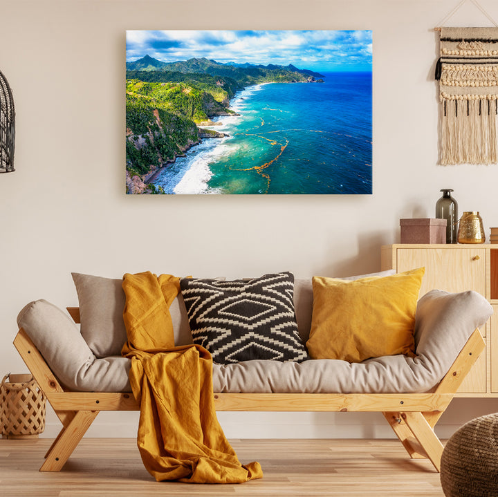 A canvas print of "Down Coast" by Yuri A Jones hung on an off-white colored wall, above a daybed style sofa.