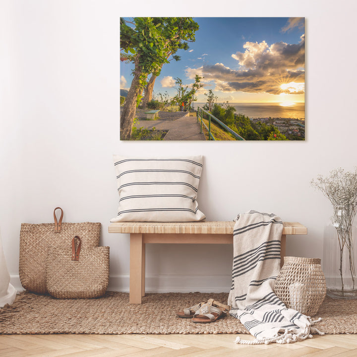 A canvas print of "Eye Spy" by Yuri A Jones one a light colored wall, above a bamboo bench.