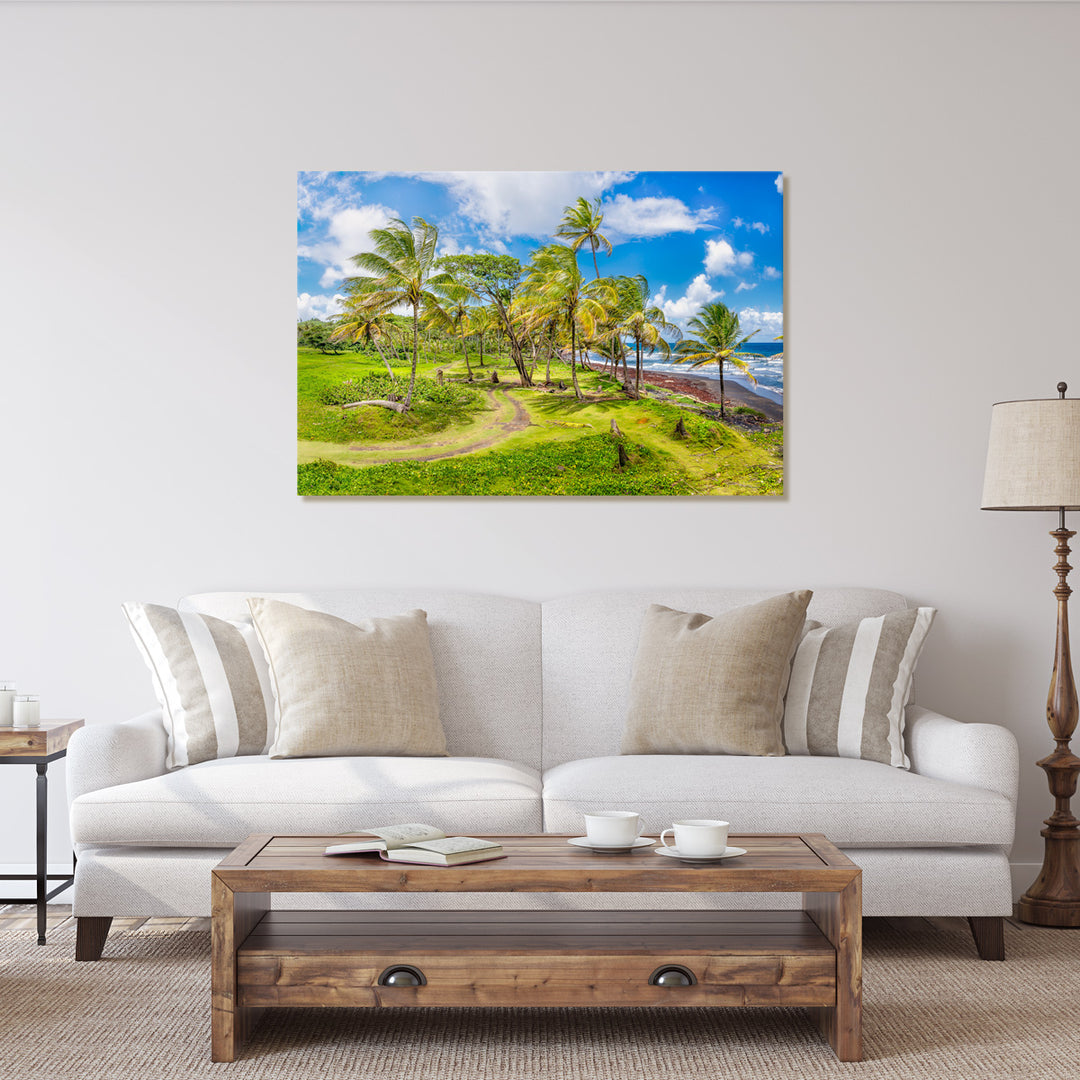 A canvas print of "Lovely Cabana Beach" by Yuri A Jones on a light colored wall, hung above a light colored sofa.