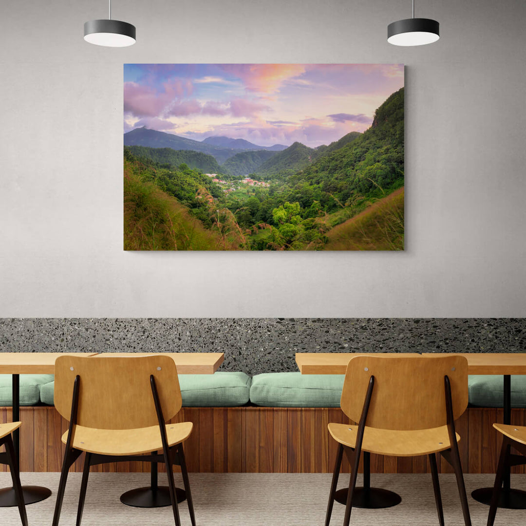 A canvas print of "Cochrane at Blue Hour" by Yuri A Jones on a restaurant wall, above a booth with green cushions.