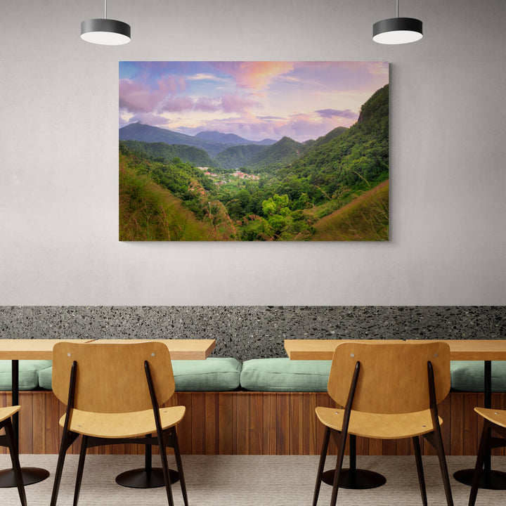 A canvas print of "Cochrane at Blue Hour" by Yuri A Jones on a restaurant wall, above a booth with green cushions.