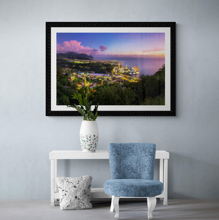 A framed art print of "Fond Cole at Dusk" by Yuri A Jones on a light colored wall, above a white wooden table with a vase.